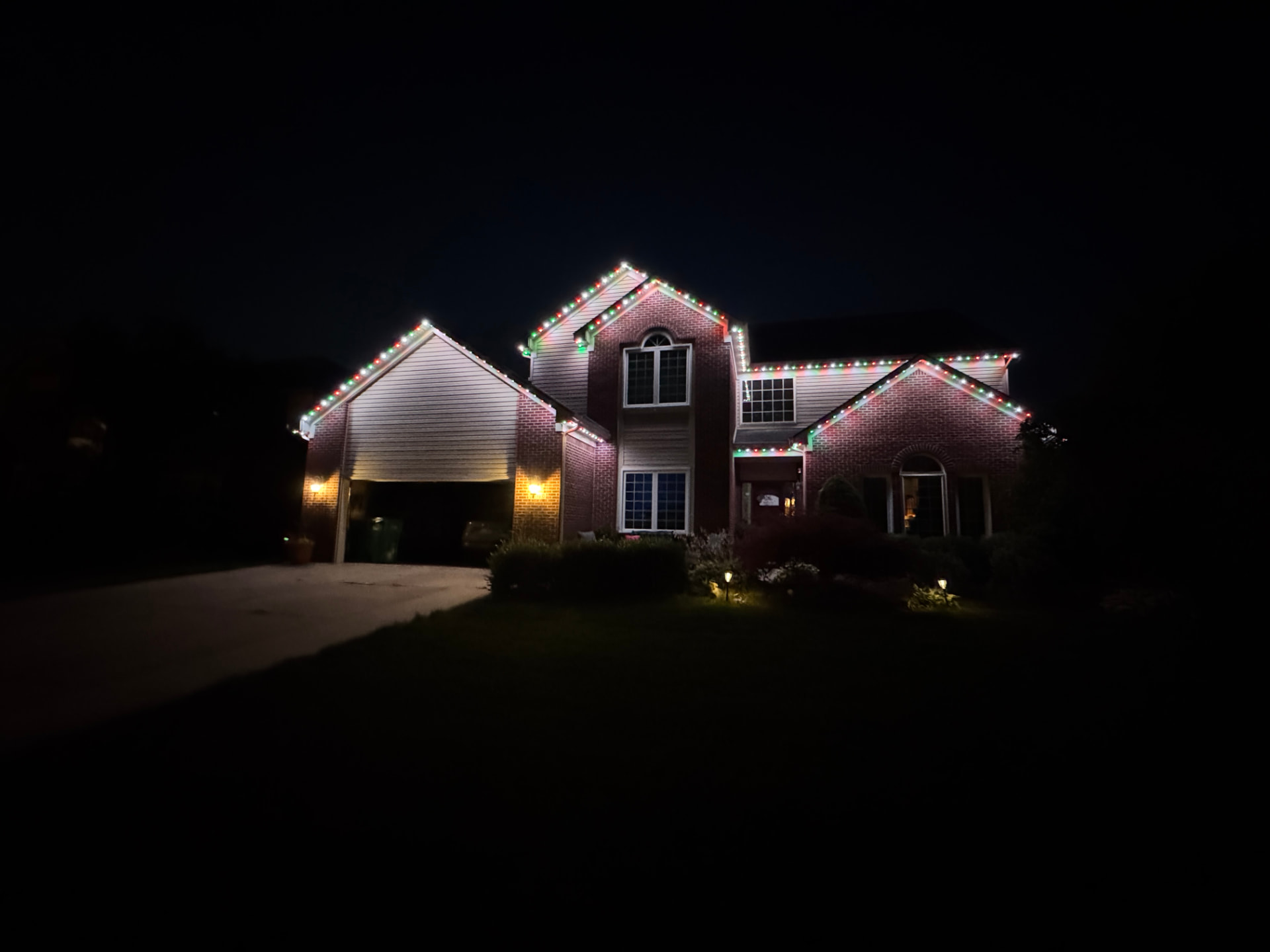 Home with red and green holiday permanent LED lighting