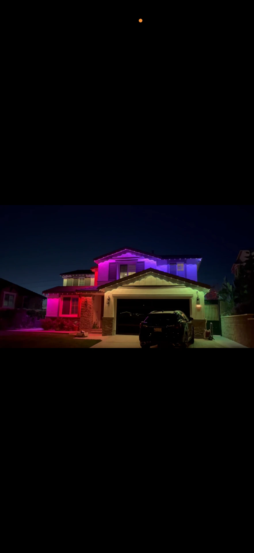 Home lit in purple, blue and pink permanent LED colors at night